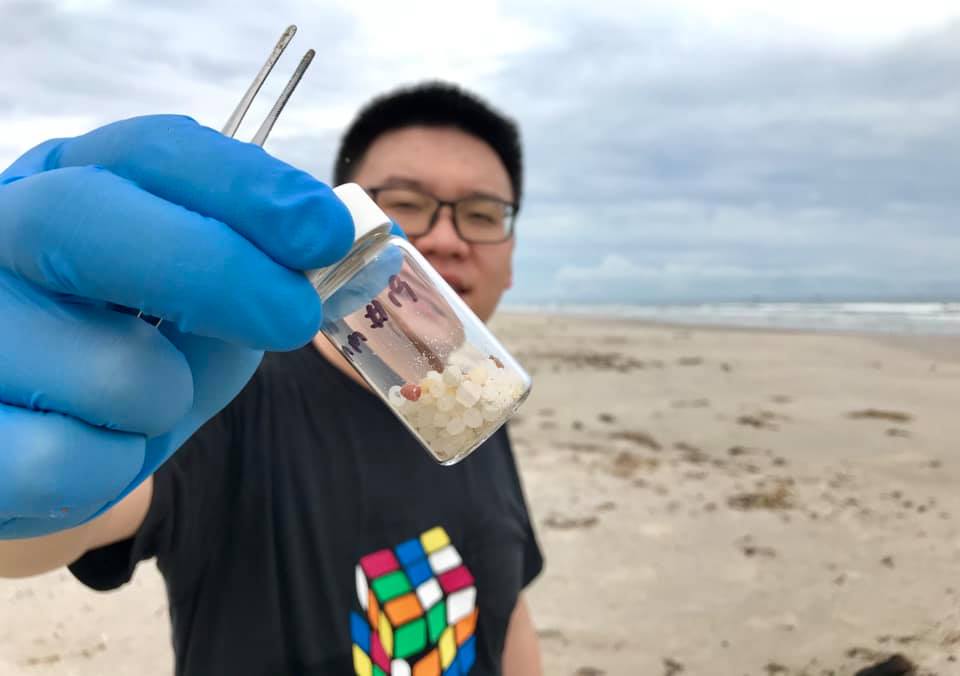 Coauthor Dr. Xiangtao Jiang, holds a sample of nurdle from Padre Island, Texas in 2021. Credit: Jace Tunnell